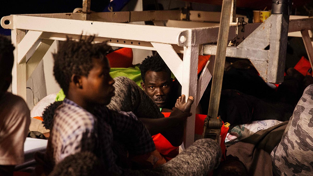 This hand-out picture taken and released on 25 June 2018 by German NGO `Mission Lifeline` off the coast of Malta shows migrants resting on board the Lifeline ship. Lifeline, a ship belonging to a German NGO of the same name, is moored about 30 nautical miles off Malta with 234 migrants who were rescued on 20 June including 14 women and four children younger than three. Photo: AFP