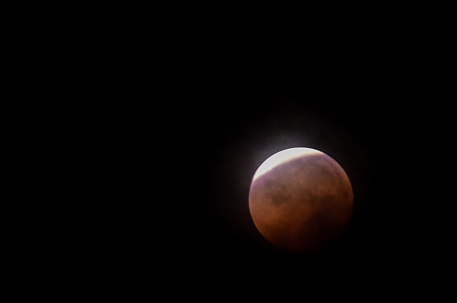 This picture shows the full moon during a `blood moon` eclipse as seen from Dhaka early on 28 July 2018. Photo: AFP