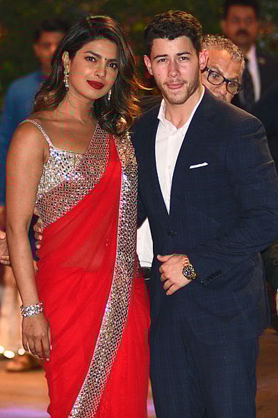 In this file photo taken on 28 June 2018, Indian Bollywood actress Priyanka Chopra (L) accompanied by US singer Nick Jonas arrive for the pre-engagement party of India`s richest man and Reliance Industries Limited chairman, Mukesh Ambani’s eldest son Akash Ambani and fiancee Shloka Mehta in Mumbai. Chopra is engaged to Jonas after a whirlwind two months of dating, People magazine, citing unnamed sources close to the pair, reported on 27 July 2018. -- AFP