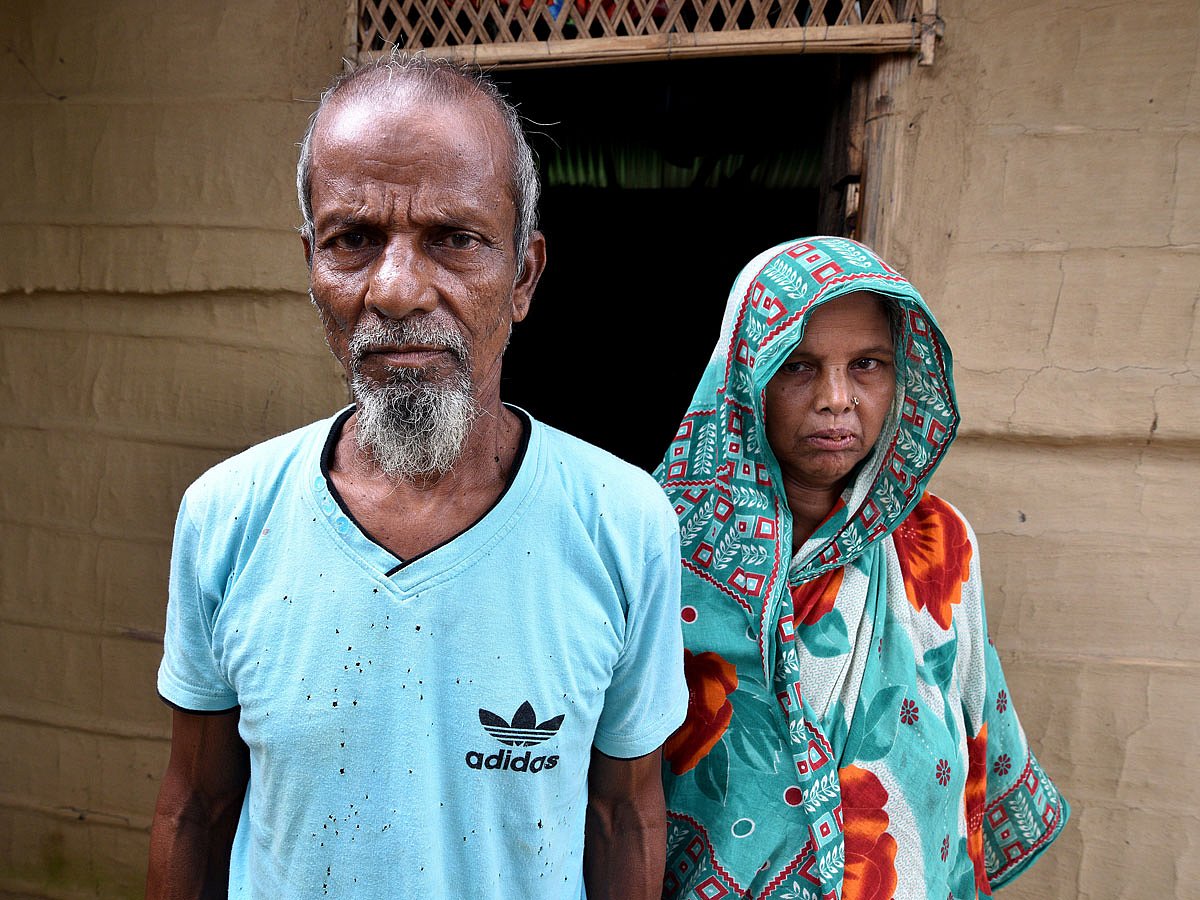 Abdul Suban, a farmer, and his wife pose for a photograph outside their home in Nellie village, in Morigaon district, in the northeastern state of Assam, India on 25 July. Photo: Reuters