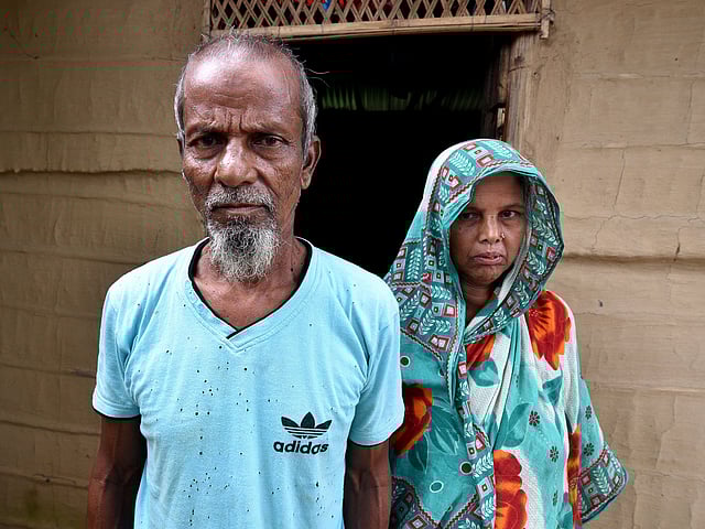 Abdul Suban, a farmer, and his wife pose for a photograph outside their home in Nellie village, in Morigaon district, in the northeastern state of Assam, India on 25 July. Photo: Reuters