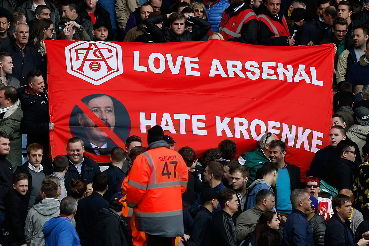 In this file photo taken on April 09, 2016 Arsenal fans hold a banner showing their dislike of Arsenal`s US Owner Stan Kroenke, following the English Premier League football match between West Ham United and Arsenal at The Boleyn Ground in Upton Park, in east London on April 9, 2016. Arsenal majority shareholder Stan Kroenke on August 7, 2018 announced an offer to buy the entire British football club, valuing it at £1.8 billion ($2.3 billion, 2 billion euros). AFP