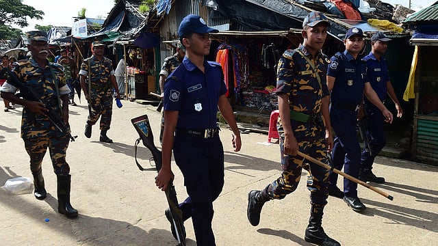 This photo taken on 18 July, 2018 shows Bangladeshi police patrolling in a Rohingya refugee camp in Teknaf. Photo: AFP