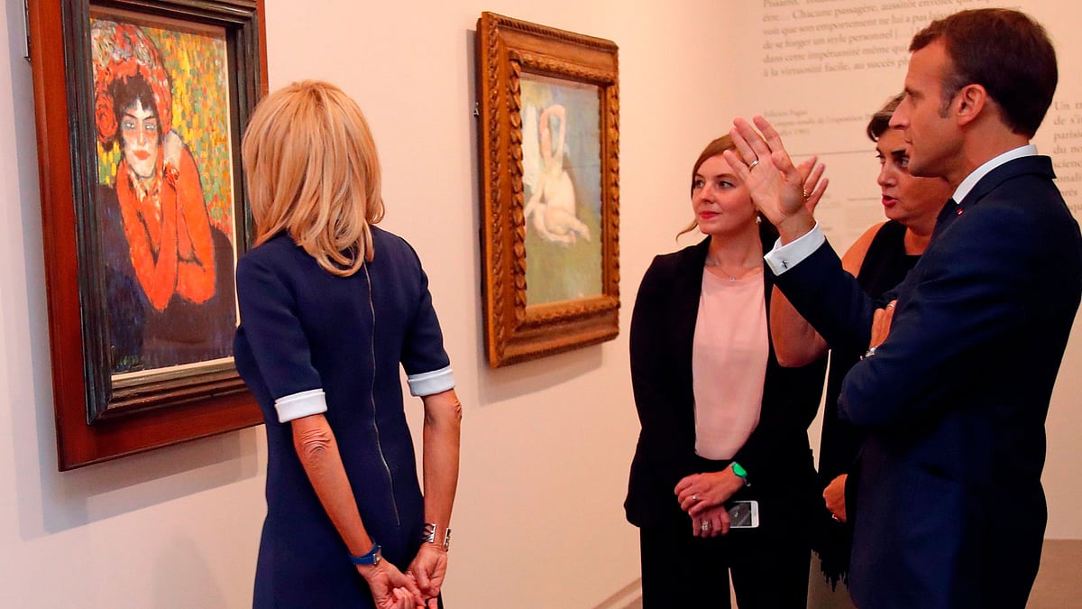 French president Emmanuel Macron (R) and his wife Brigitte Macron (L) speak with officials as they visit the `Picasso. Bleu et rose` (Picasso. Blue and Rose) exhibition dedicated to Pablo Picasso’s blue and rose periods at The Musee d`Orsay in Paris on 14 September. Photo: AFP