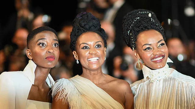 In this file photo taken on 9 May Kenyan actress Samantha Mugatsia, Kenyan director Wanuri Kahiu and Kenyan actress Sheila Munyiva pose as they arrive for the screening of the film `Rafiki` at the 71st edition of the Cannes Film Festival in Cannes, southern France. Photo: AFP