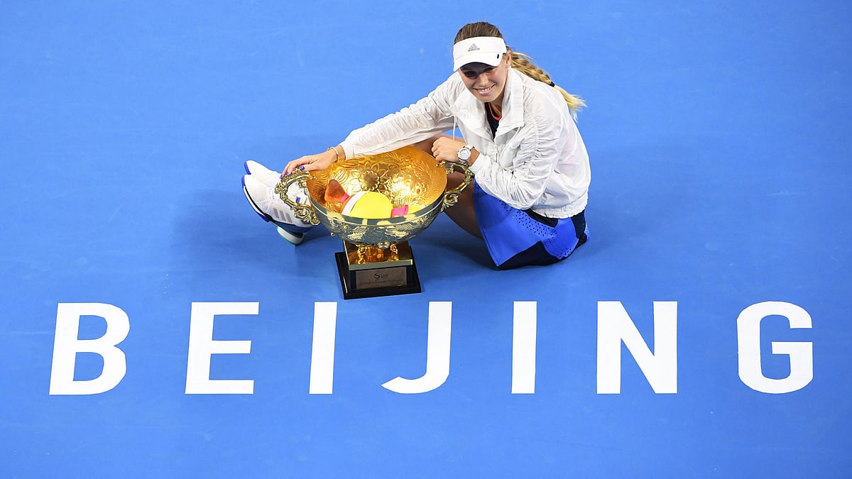 Caroline Wozniacki of Denmark poses with the trophy after winning the women`s final against Anastasija Sevastova of Latvia at the China Open. Photo: AFP