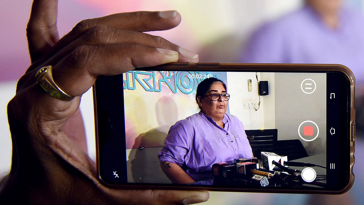 Indian Bollywood writer-producer Vinita Nanda is seen on a mobile phone screen during a press conference in Mumbai on 9 October 2018. Nanda is the latest among women to come out openly among many after Indian actress Tanushree Dutta, whose recent public account of alleged sexual harassment by actor Nana Patekar has sparked an outpouring of similar #MeToo accounts across the country. -- Photo: AFP