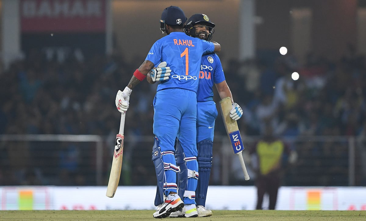 Indian cricket captain Rohit Sharma (R) hugs teammate K.L Rahul after scoring a century during the second T20 cricket match between India and West Indies at the Bharat Ratna Atal Bihari Vajpayee Ekana Cricket Stadium in Lucknow on 6 November 2018. Photo: AFP