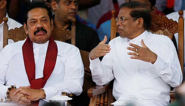 Sri Lanka`s newly appointed Prime Minister Rajapaksa and President Sirisena talk during a rally near the parliament in Colombo. Photo: Reuters