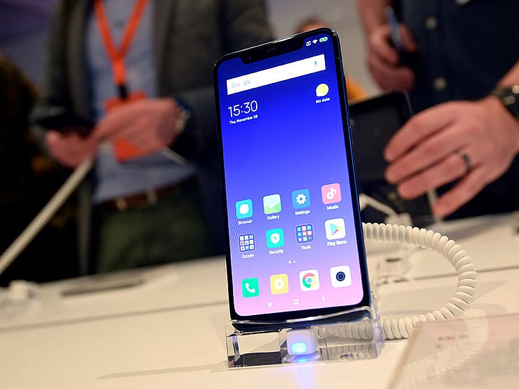 Guests view the Xiaomi Mi 8 smartphone at a UK launch event in London. Photo: Reuters
