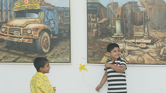 Two children at the annual artwork exhibition organised by the drawing and painting department of the fine arts faculty at Dhaka University on 15 November. Photo: Abdus Salam