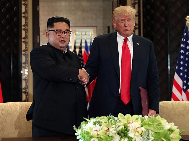 US president Donald Trump shakes hands with North Korea`s leader Kim Jong Un after they signed documents that acknowledged the progress of the talks and pledge to keep momentum going, after their summit at the Capella Hotel on Sentosa island in Singapore on 12 June. Photo: Reuters