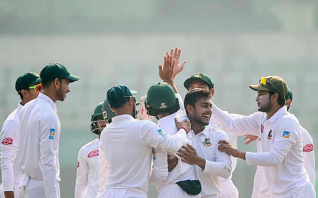 Bangladesh cricketer Shakib Al Hasan (R) congratulate teamamte Mehidy Hasan (2nd R) after the dismissal of the West Indies cricketer Devendra Bishoo during the third day of the second Test cricket match between Bangladesh and West Indies at the Sher-e-Bangla National Cricket Stadium in Dhaka on 2 December, 2018. Photo: AFP