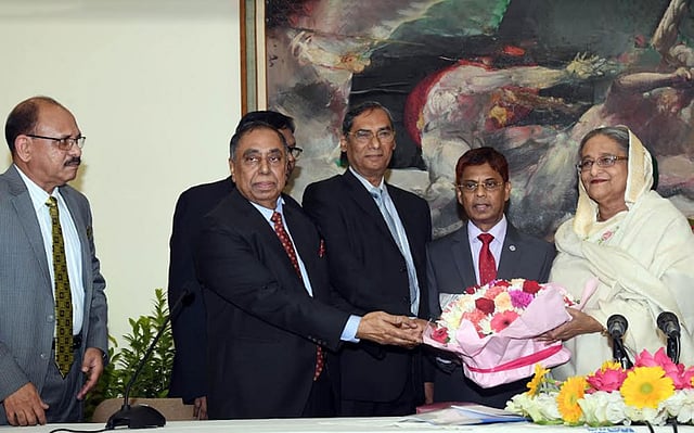 Prime minister Sheikh Hasina receives a bouquet of flowers from retired police officers at a function at her official residence Ganabhaban on Thursday. Photo: PID