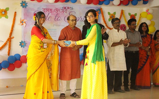 A faculty member of the English department is handing over a prize to the winner of a poetry recitation and storytelling competition at the central auditorium of the university at Khagan, Savar, Dhaka on 13 February. Photo: Collected