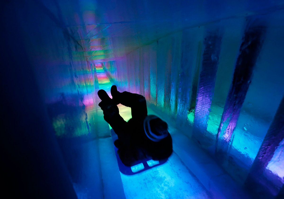 In this 26 January 2019 photo, a man zooms down a 97-foot ice slide at Ice Castles in North Woodstock, NH. Photo: AP