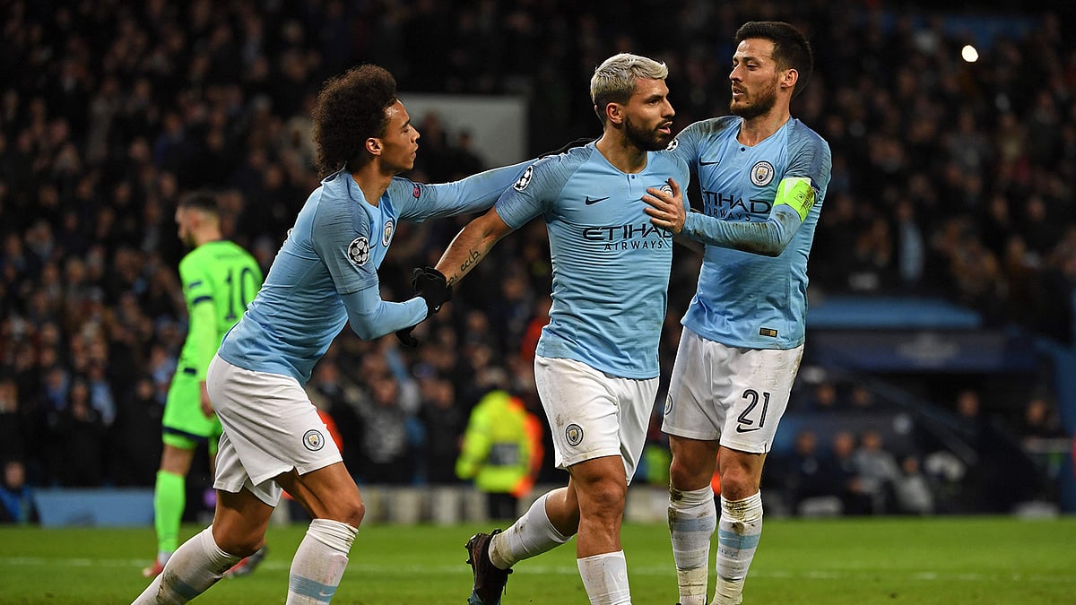 Manchester City’s Argentinian striker Sergio Aguero © celebrates with Manchester City’s German midfielder Leroy Sane (L) and Manchester City’s Spanish midfielder David Silva ® after scoring the opening goal from the penalty spot during the UEFA Champions League round of 16 second leg football match between Manchester City and Schalke 04 at the Etihad Stadium in Manchester, north west England, on March 12, 2019. AFP