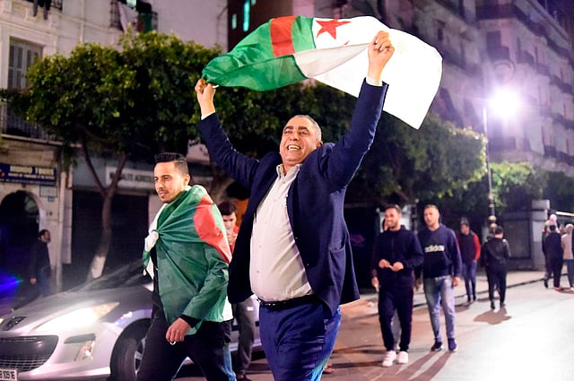 Algerians celebrate after Algeria`s veteran president Abdelaziz Bouteflika informed the Constitutional Council that he is resigning, in Algiers on 2 April 2019. Photo: AFP