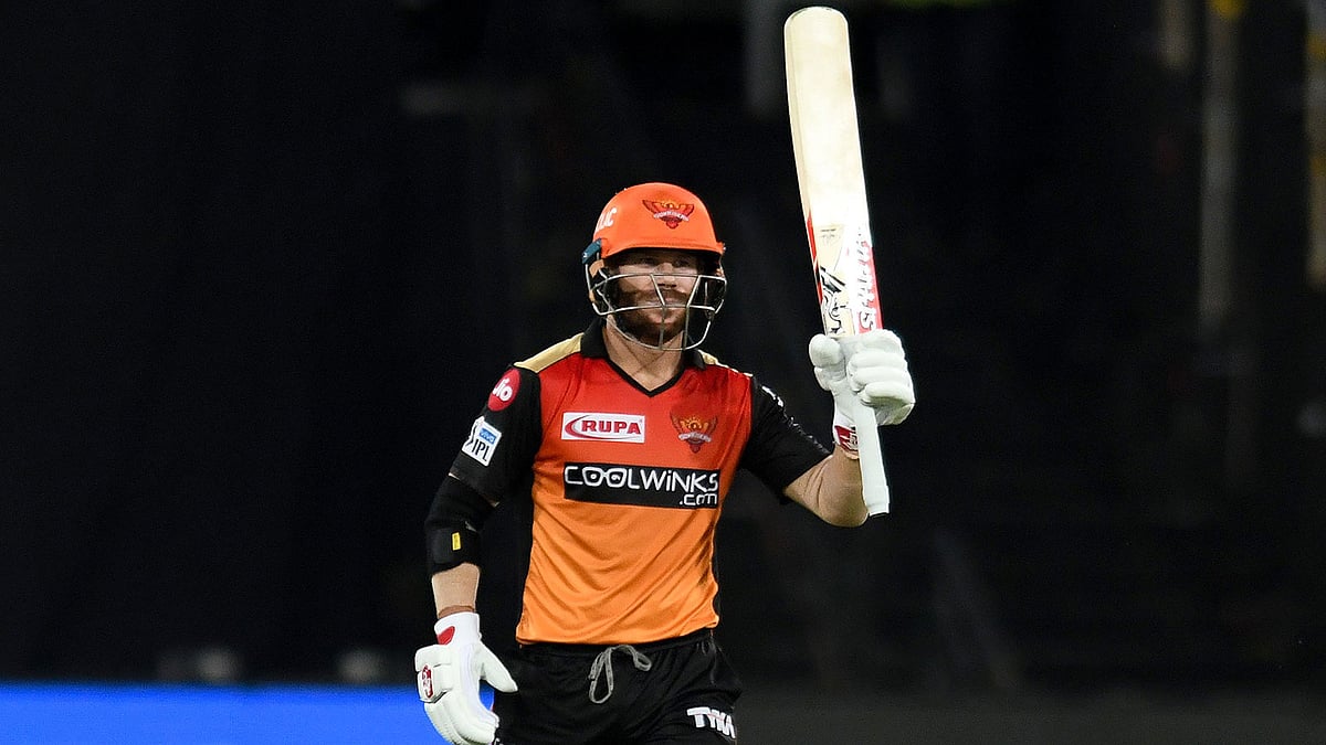 Sunrisers Hyderabad cricketer David Warner raises his bat after scoring fifty (50) runs during the 2019 Indian Premier League (IPL) Twenty20 cricket match between Sunrisers Hyderabad and Kolkata Knight Riders at the Rajiv Gandhi International Cricket Stadium in Hyderabad on 21 April 2019. Photo: AFP