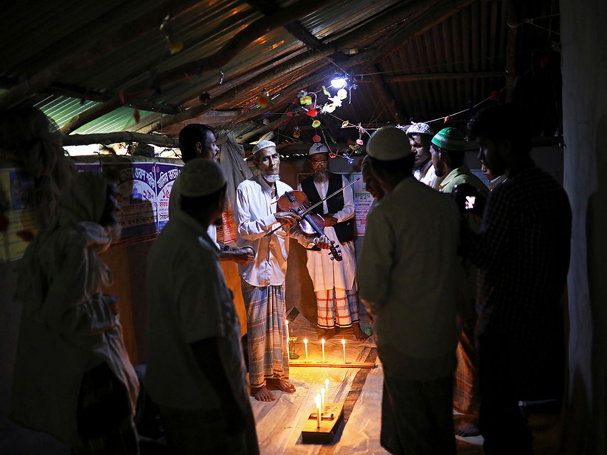 Amir Ali, a Rohingya violinist who was a member of a wedding band of the northern Rakhine State of Myanmar, plays the violin during a weekly prayer event at the Kutupalong refugee camp in Cox`s Bazar, Bangladesh, on 7 March 2019. Reuters