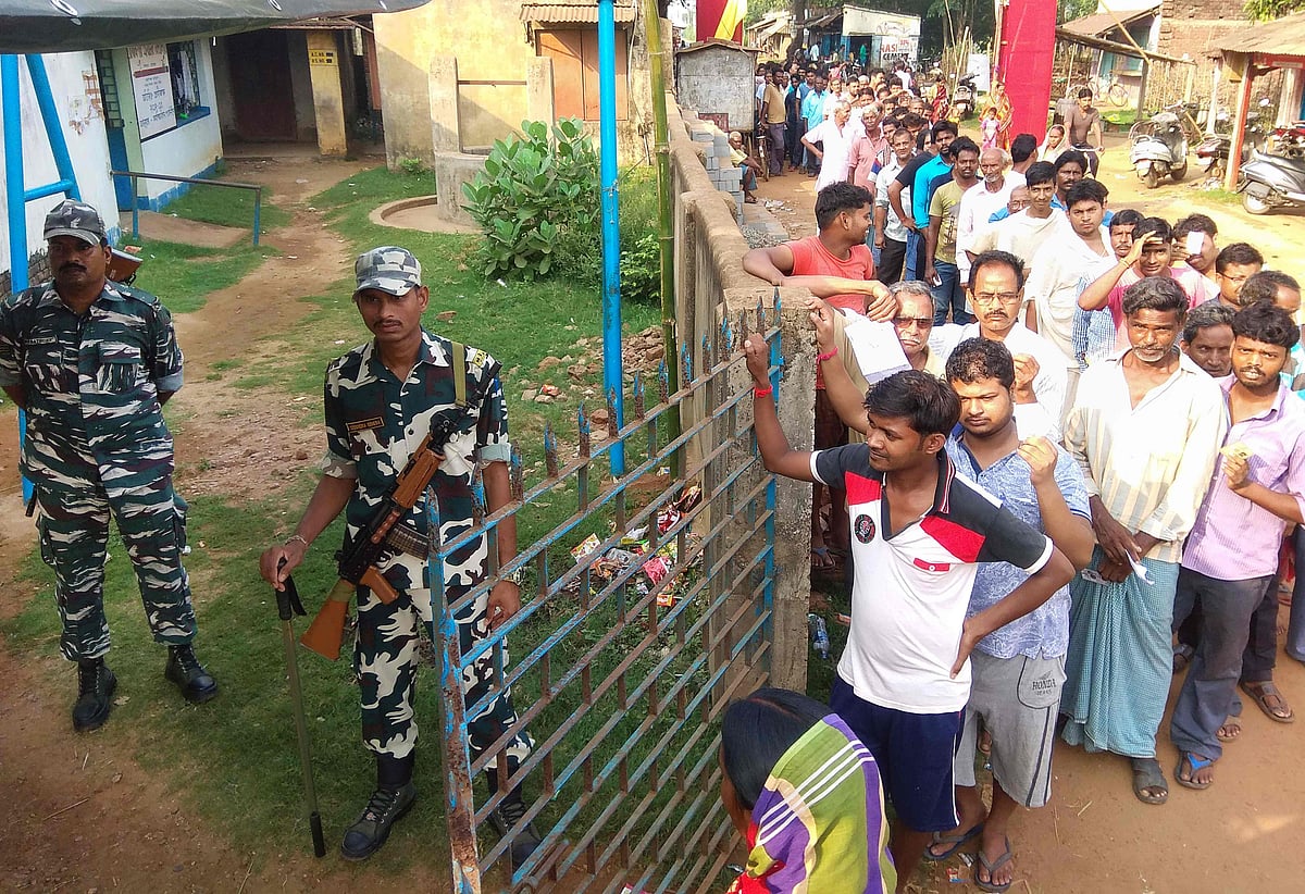 Voters queue up at a polling station to cast their ballots during the sixth phase of India`s general election in Jhargram in West Bengal state on 12 May 2019. Photo: AFP