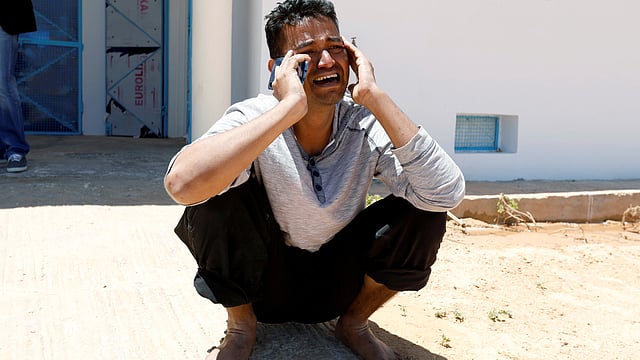 One of a migrants, who were rescued after their boat capsized in the Mediterranean Sea off the Tunisian Coast after they had left Libya, is seen inside a local Red Cresent chapter in Zarzis, Tunisia on 11 May 2019. Photo: Reuters