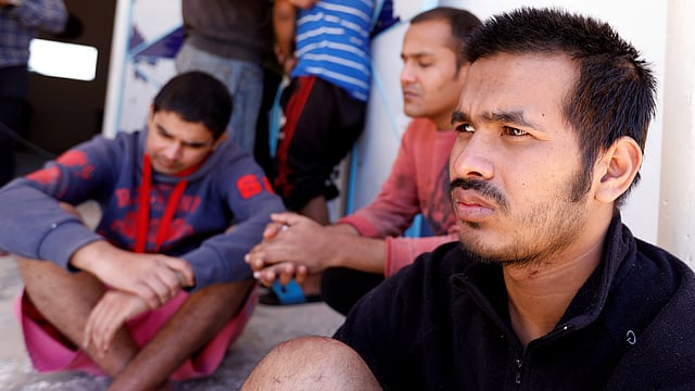 Migrants, who were rescued after their boat capsized in the Mediterranean Sea off the Tunisian Coast after they had left Libya, are seen inside a local Red Cresent chapter in Zarzis, Tunisia on 11 May 2019. Photo: Reuters