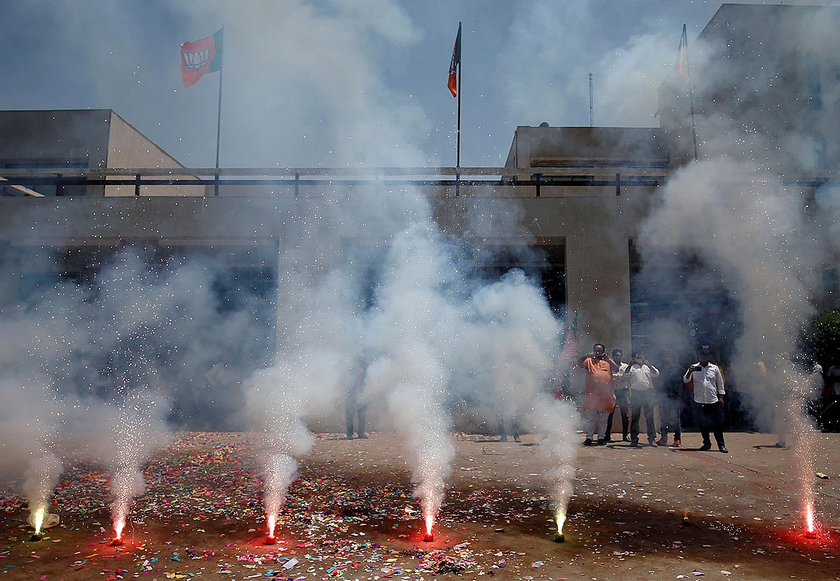 Supporters of Bharatiya Janata Party (BJP) celebrate after learning of initial poll results outside the party office in Gandhinagar, India, on 23 May 2019. Reuters
