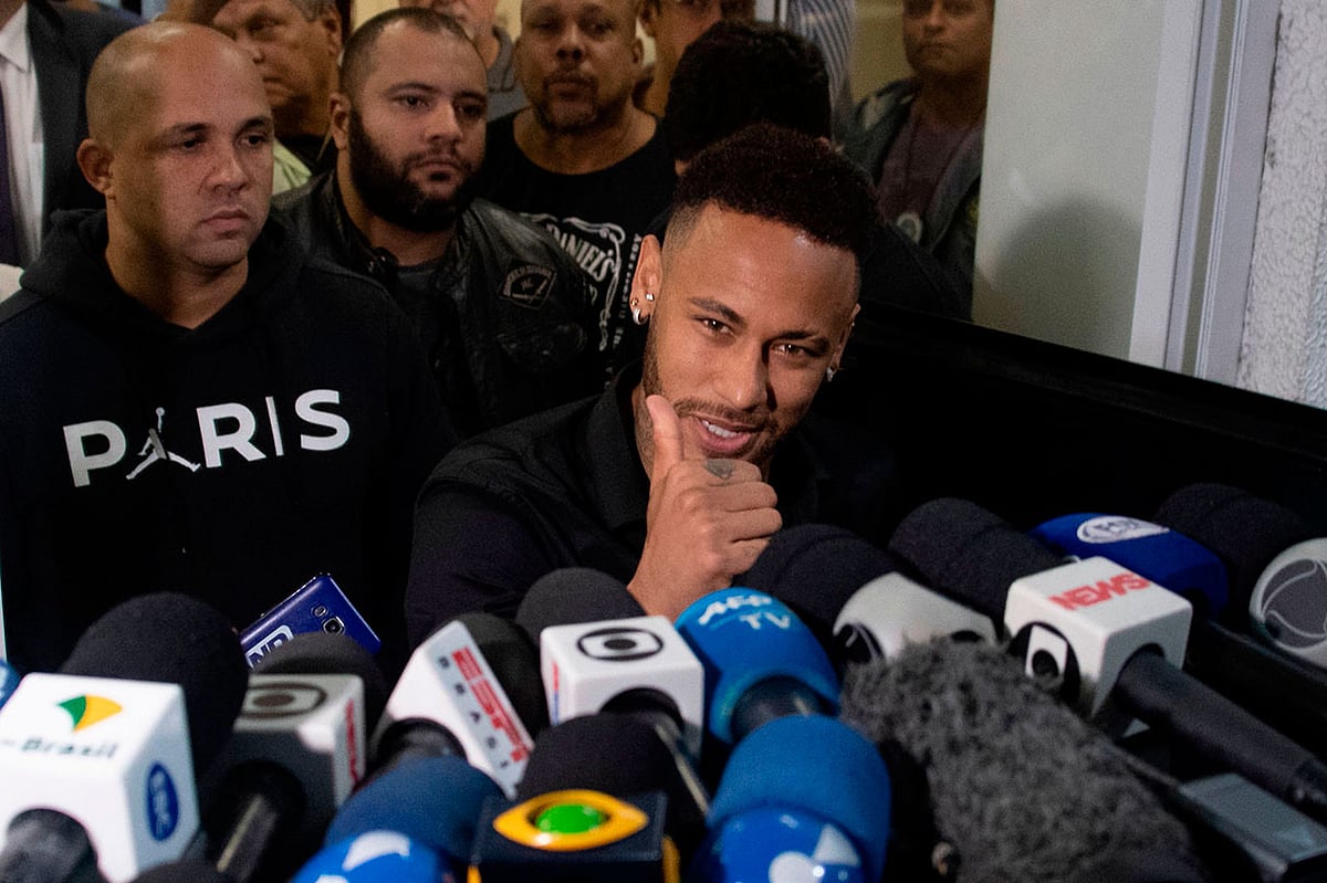 Brazil`s star striker Neymar gives the thumb up as he leaves a Police Station after giving a statement to police for posting intimate WhatsApp messages with Najila Trindade Mendes de Souza, who has accused of rape, on social media, at the Internet Crime Special Police Unit in Rio de Janeiro, Brazil on 6 June 2019. Photo: AFP