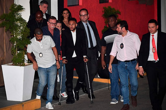 Brazilian football player Neymar (5-R) leaves on crutches from the Women`s Defence Precinct in Sao Paulo, Brazil, on 13 June 2019, after testifying due to Brazilian Najila Trindade filed a complaint against him on 31 May, saying he assaulted her after inviting her to visit him in Paris. Photo: AFP
