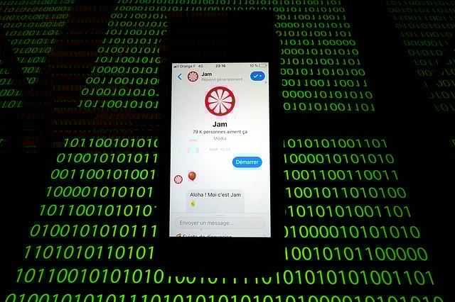 This file photo taken on 28 February 2019 shows the `Jam` chat bot displayed on a smartphone and a binary code displayed by a tablet in Paris. Some traditional news media as well as start-ups rely on `chatbots`, computer programs that provide knowledge online based on a fun conversation with a connected audience. The `Jam` chat bot for example is a robot which tells stories to enrich the news and to strengthen general knowledge. Photo: AFP
