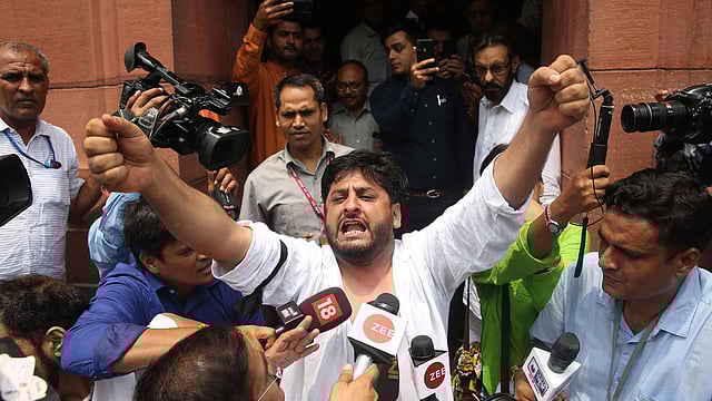 Fayaz Ahmad Mir (C) member of Parliament representing the state of Jammu & Kashmir in Rajya Sabha protests outside the Parliament house in New Delhi on 5 August, 2019. The Indian government on August 5 rushed through a presidential decree to scrap a special status for disputed Kashmir, hours after imposing a major security clampdown in the region. Photo: AFP