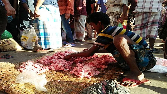 A man sells beef cheap at a makeshift meat market at Malibagh railway crossing, Dhaka on Monday. Photo: UNB