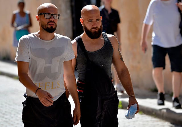 Men with beardwalk along a street of Havana, on 17 July 2019. Photo: AFP