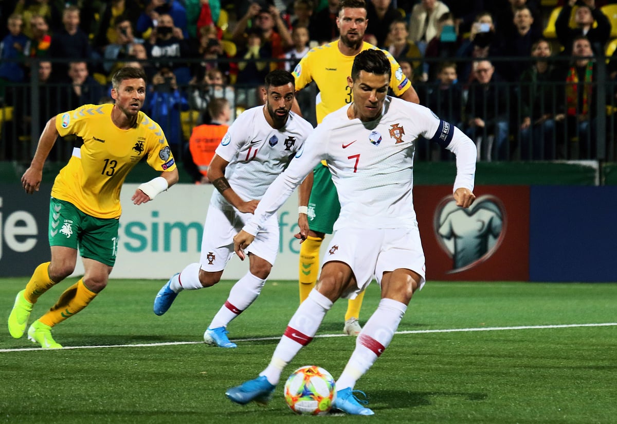 Portugal`s forward Cristiano Ronaldo scores the opening goal from the peanlty spot during the UEFA Euro 2020 Group B qualification football match Lithuania v Portugal in Vilnius, Lithuania, on September 10, 2019. AFP