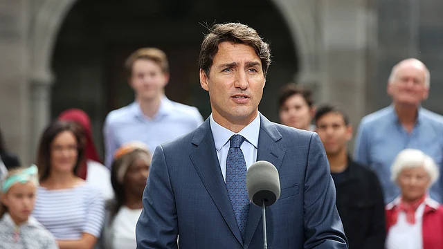 his handout image obtained 19 September 2019, courtesy of Time magazine, off the Time Twitter feed shows Canada`s prime minister Justin Trudeau wearing brown face at a party in 2001. photo: AFP