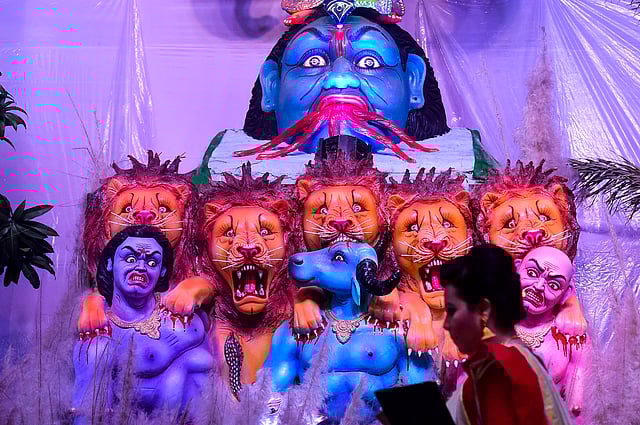 A Bangladeshi hindu devotee walk past the goddess Durga as she arrives for a prayer during at the Durga Puja festival at a temple in Dhaka, Bangladesh, on 4 October 2019. Photo: AFP