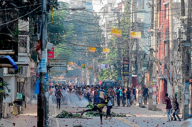 Stranded Bihari residents shout slogans and throw stones during a clash with security forces at Geneva Camp in Dhaka on 5 October 2019. Photo: AFP