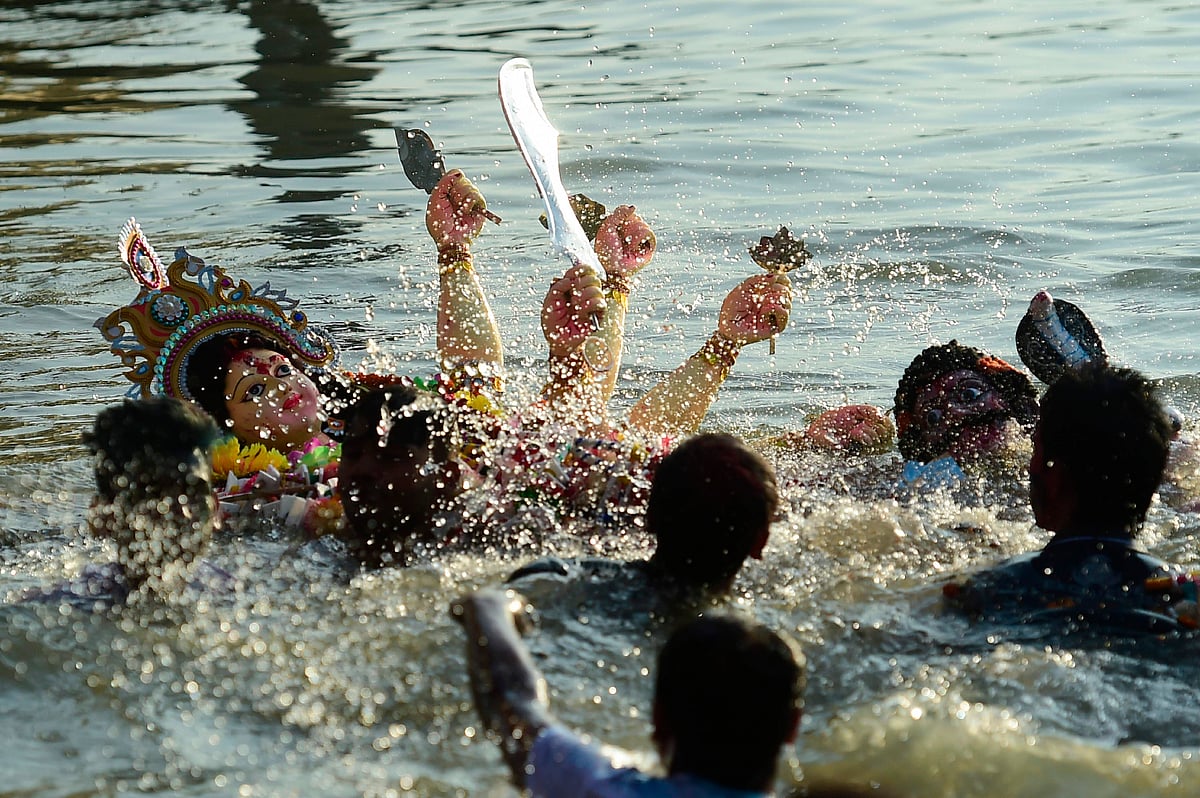 Hindu devotees submerge a clay idol of the Hindu goddess Durga on the final day of the Durga Puja festival in Dhaka on 8 October 2018. Photo: AFP