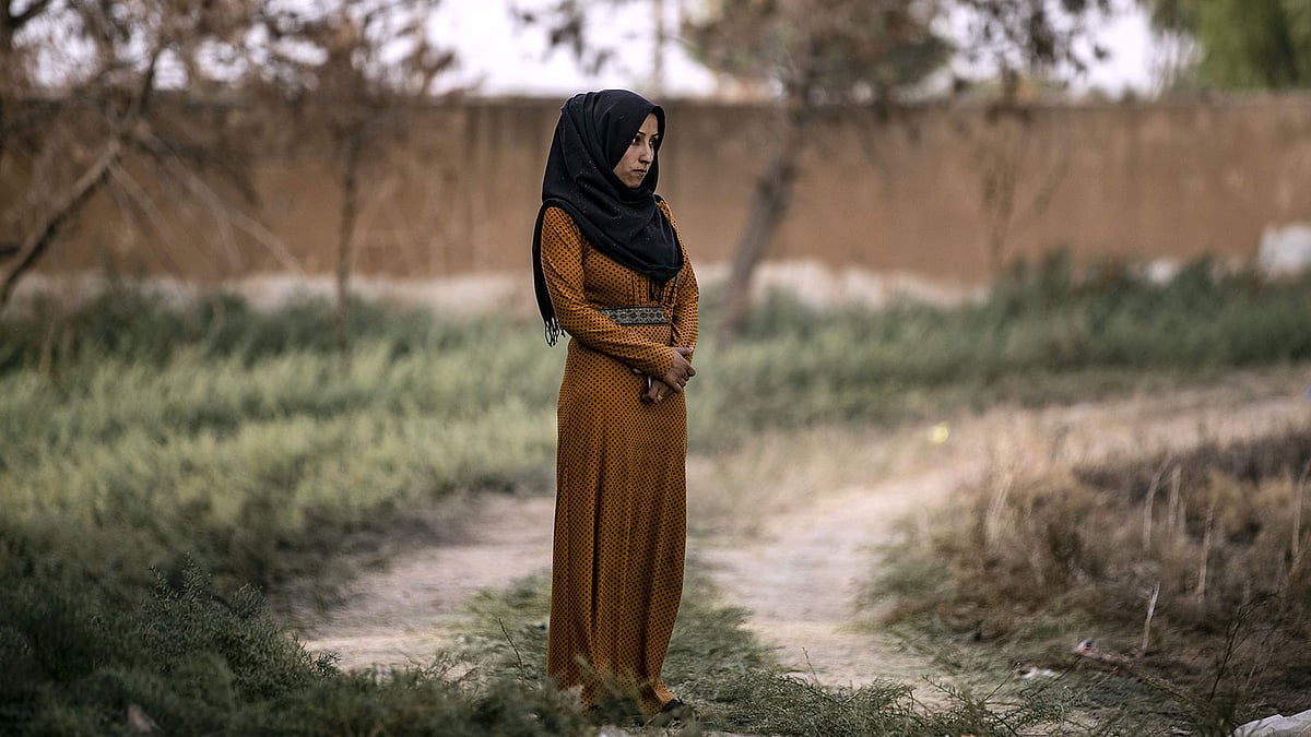 A displaced Syrian women is pictured as Arab and Kurdish civilians flee amid Turkey`s military assault on Kurdish-controlled areas in northeastern Syria on 11 October 2019 in the town of Tal Tamr in the countryside of Syria`s northeastern Hasakeh province. Photo: AFP