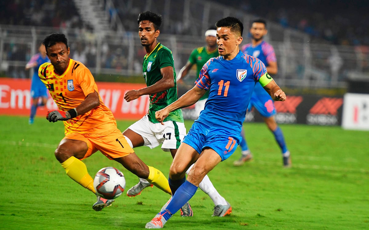 India`s football captain Sunil Chhetri (R) vibes for the ball during the World Cup 2022 and 2023 AFC Asian Cup qualifying football match between India and Bangladesh at the Vivekananda Yuba Bharati Krirangan in Kolkata on 15 October 2019. Photo: AFP