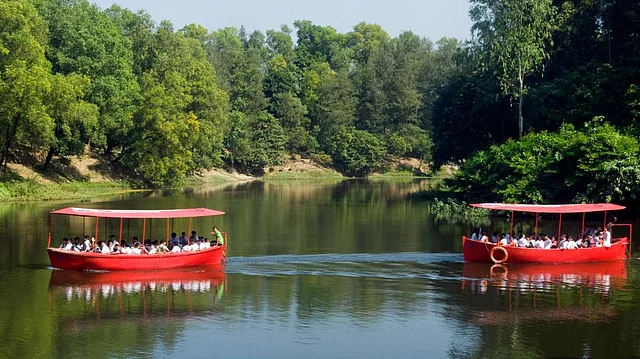 Tourists take boat rides in Foy`s Lake, Chattogram. Photo: Prothom Alo