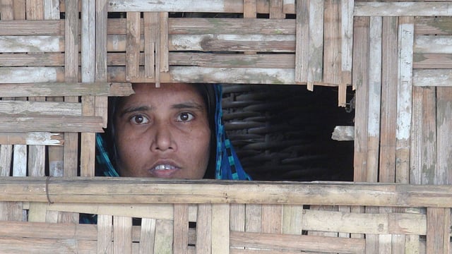 Mentally ill Korsina peeps through a window of a room, where she is reported tied to shackles for 8 years in Panchagarh sadar upazila. Photo: UNB