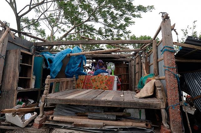 A woman gathers her belongings from a house after cyclone Bulbul hit the area in Koyra, some 100 km from Khulna on 10 December 2019. AFP File Photo