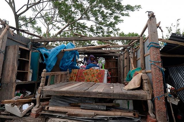 A woman gathers her belongings from a house after cyclone Bulbul hit the area in Koyra, some 100 km from Khulna on 10 December 2019. AFP File Photo