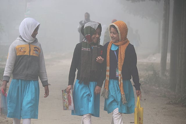 Students walking to school in a foggy morning at Uttam Baniapara in Rangpur on 14 December 2019. Photo: Moinul Islam