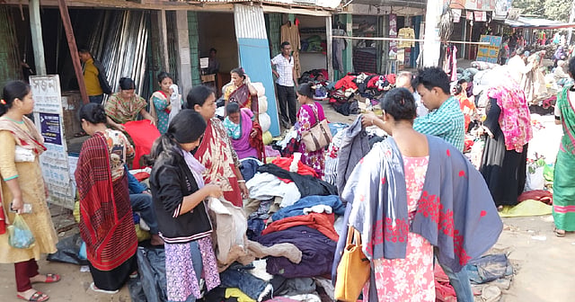 People buy warm clothes from a shop of old cloths in Rangamati. Photo: UNB