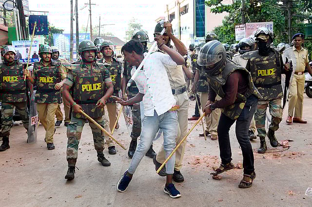 In this file picture taken on 19 December 2019, policemen with sticks locally known as `lathi` beat a protester during a demonstration against India`s new citizenship law in Mangalore. Photo: AFP