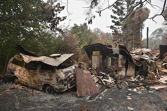 A house and van are seen destroyed after bushfires ravaged the town of Bilpin, 70km west of Sydney on 29 December 2019. Photo: AFP