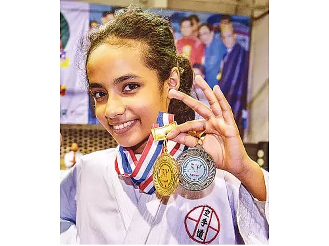 Doyeeta Binte Din poses for a picture with her medals. Photo: Collected